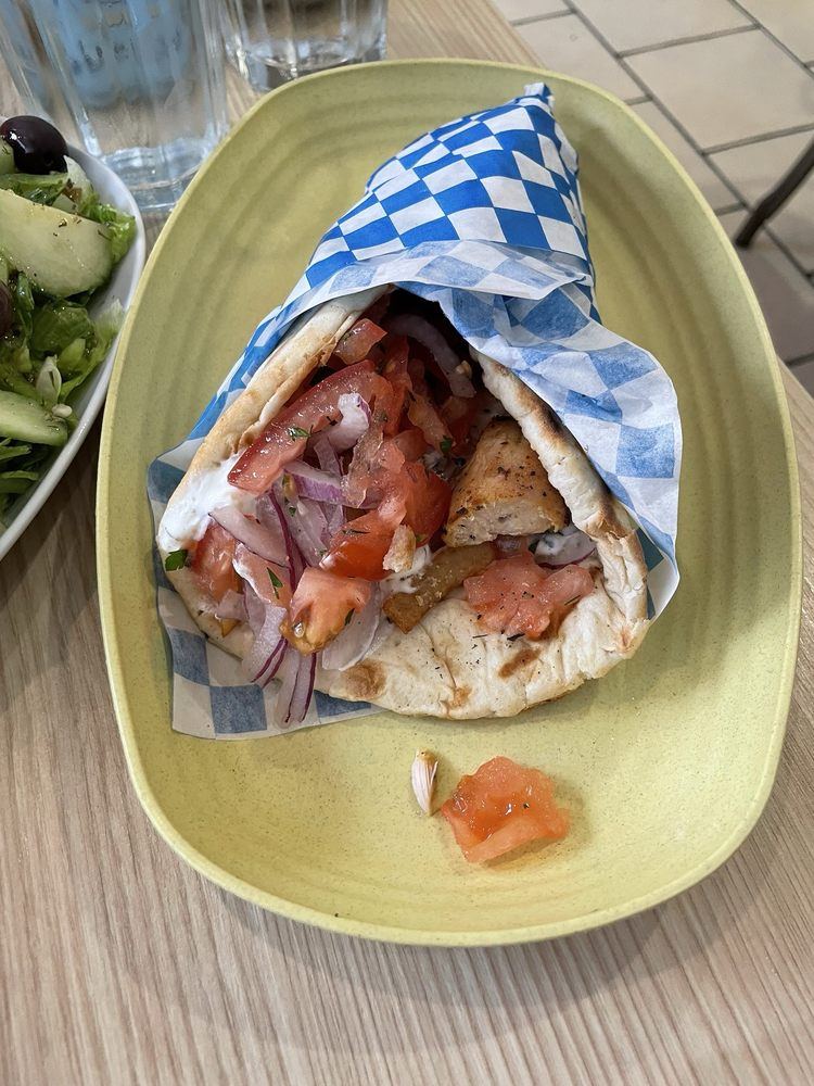 Chicken pita wrapped in blue and white checked paper