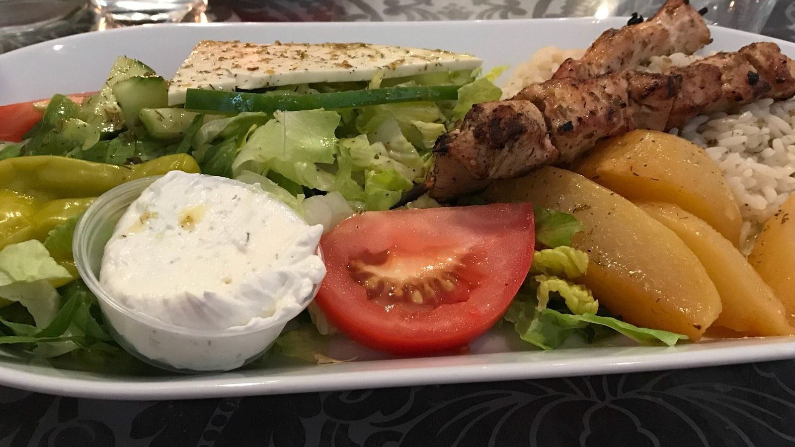 Souvlaki platter with pita, Greek salad, tzatziki and lemon potatoes